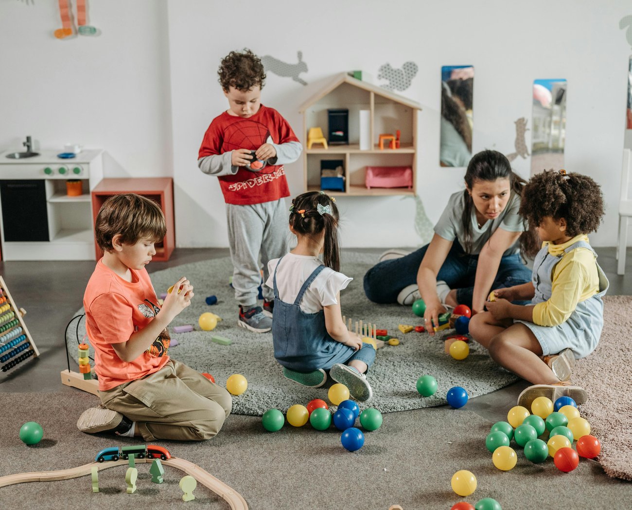 Nursery playworker guiding the children towards a fun and enjoyable day