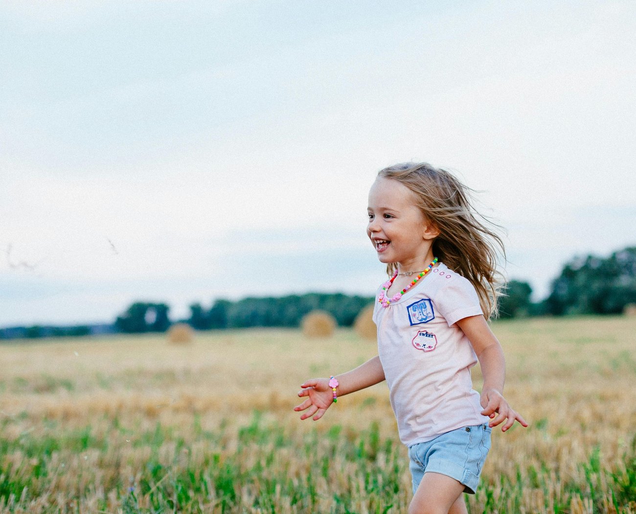A neurodivergent child enjoying playing in a field